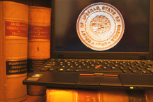Computer with Court of Appeals seal; books in background
